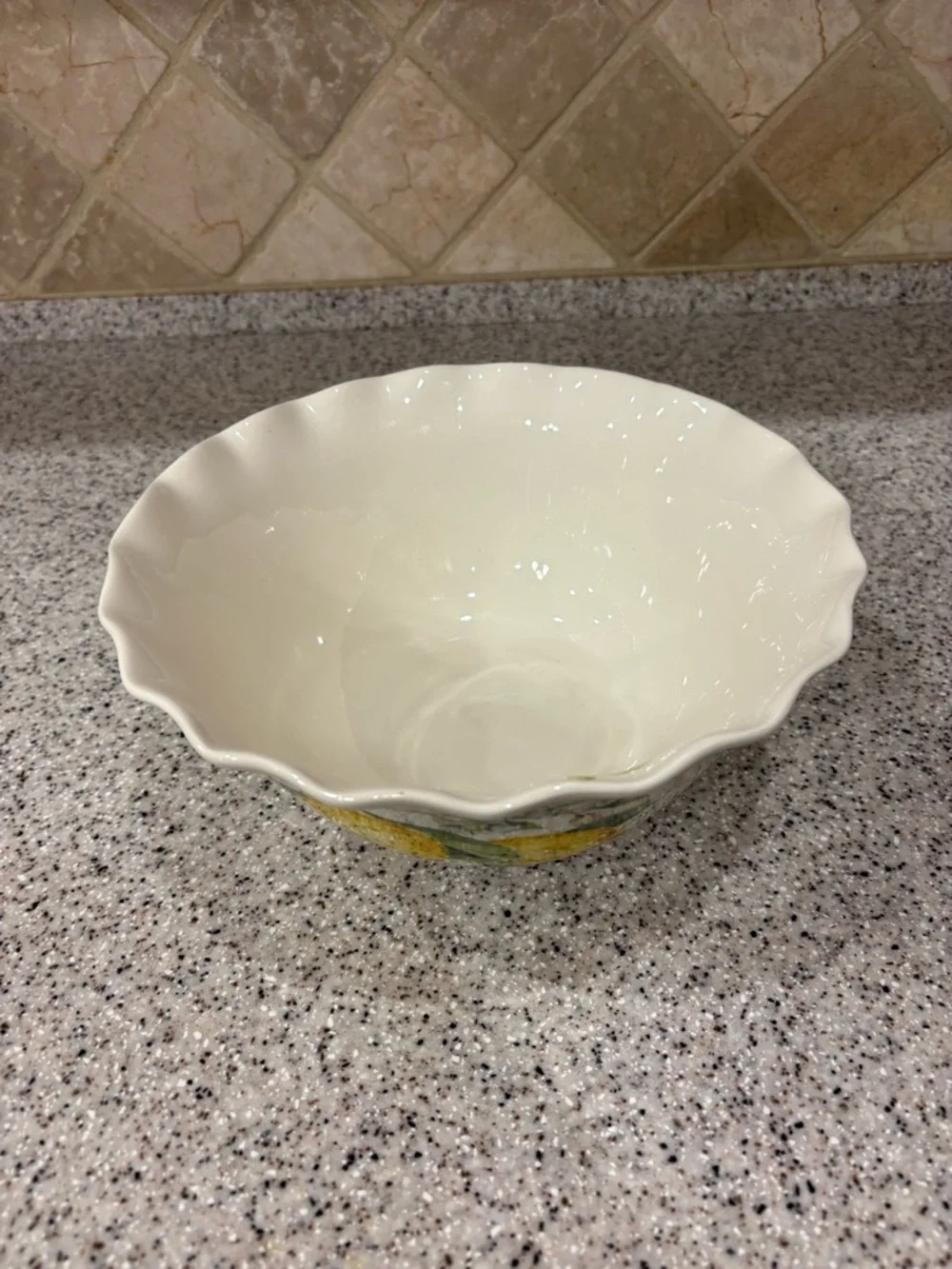 Hand-painted ceramic ruffle bowl featuring lemon motifs. Never Used. Display